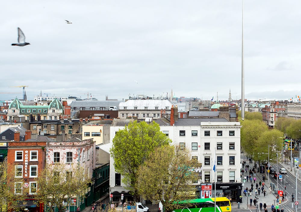 Aerial view of Dublin's O'Connell Street with the Spire, historic buildings, and city traffic