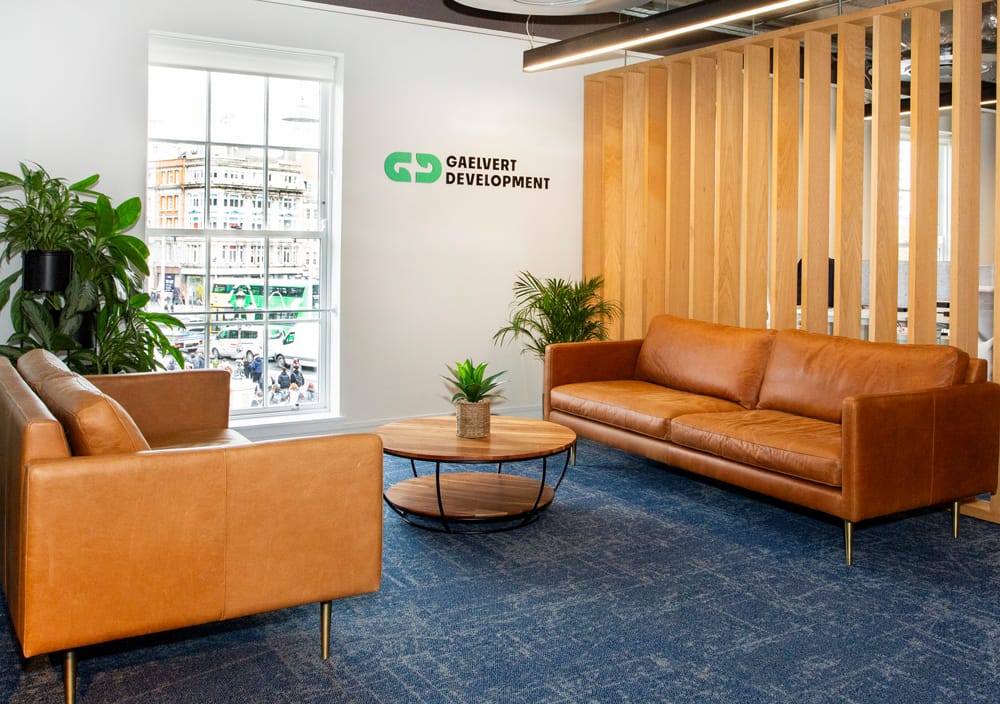 Gaelvert Development office reception area with leather sofas and wooden slat wall