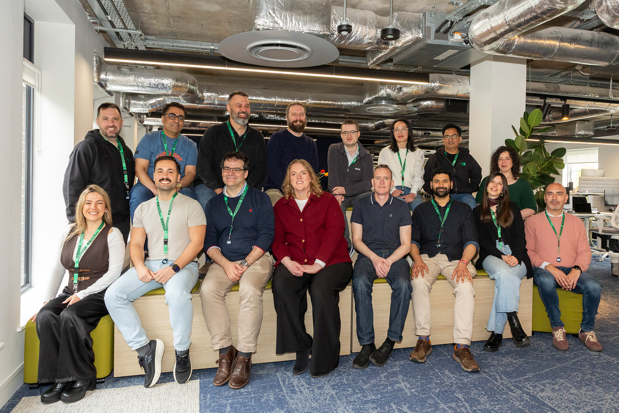 Full team group photo smiling together in the office
