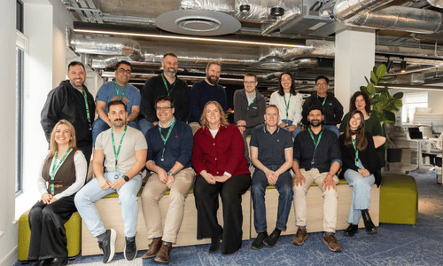 Full team group photo smiling together in the office